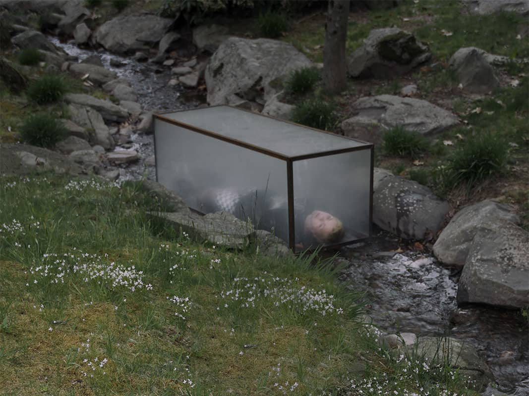 a creek and person inside a box made of a semi-opaque material