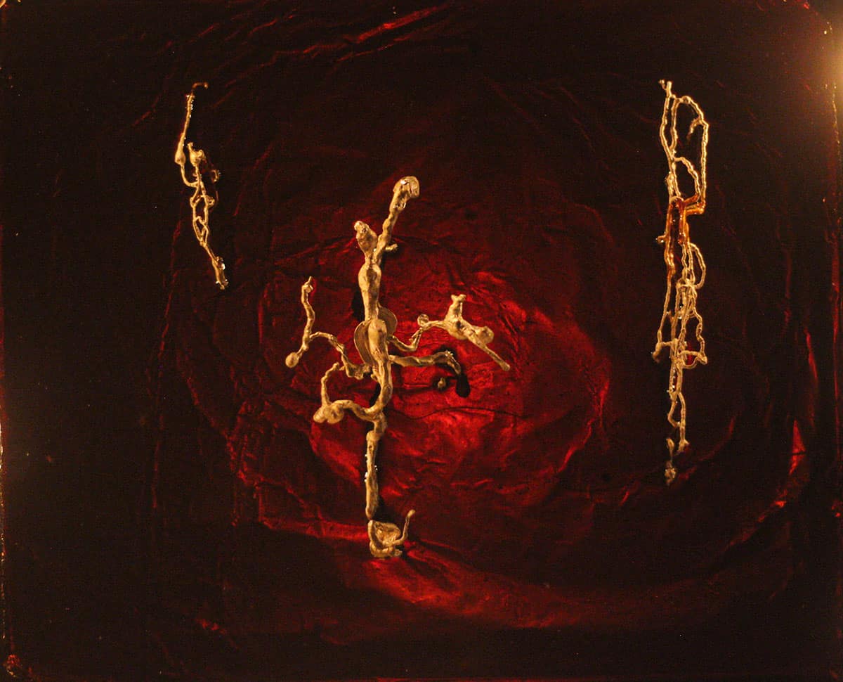 photograph of sculpture: red resin and abstract silver veins.